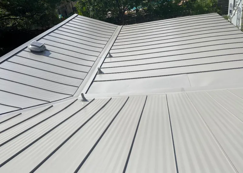 Solar attic fan installed on a metal roof for Roof Ventilation in Rockingham